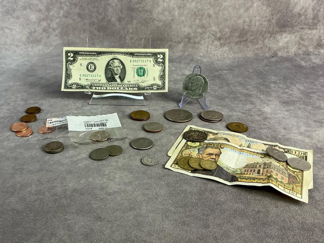 Foreign & Domestic Currency: Foreign and domestic currency including some pre 1964 coins containing 90 percent silver. All in good circulated condition. Total weight for silver coins is 0.62 ozt.