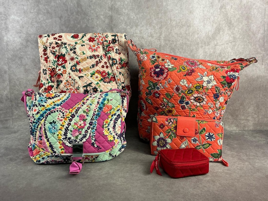Vera Bradley Bags & More: Three quilted Vera Bradley purses, one with matching wallet and red pill carrier. All in good condition with vibrant patterns. Largest measures 11 inches wide x 12.5 inches tall.