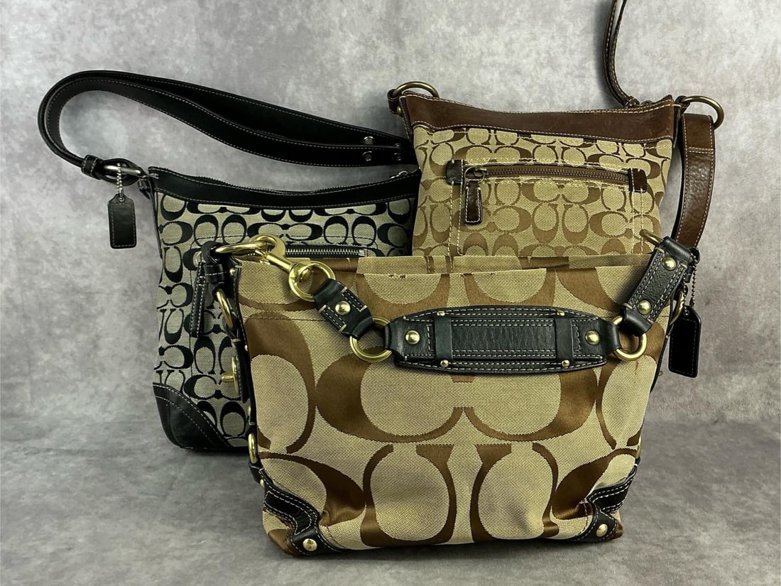 Coach Bags: Three Coach signature hobo bags. Two in brown and one in black. All in good condition with minor fraying to one. Largest one measures 9.25 inches wide x 10.5 inches tall.