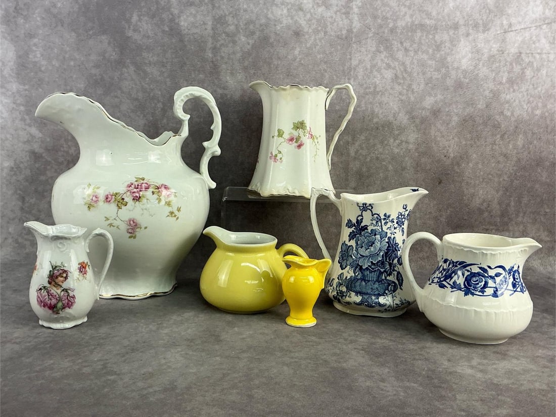 Pitcher Delight: Six porcelain pitchers including Cornflower by Wedgewood, Pope Gosser made in the USA and more. All in fair to good condition with several having crazing. Largest measures 4 inches at base x 9.5