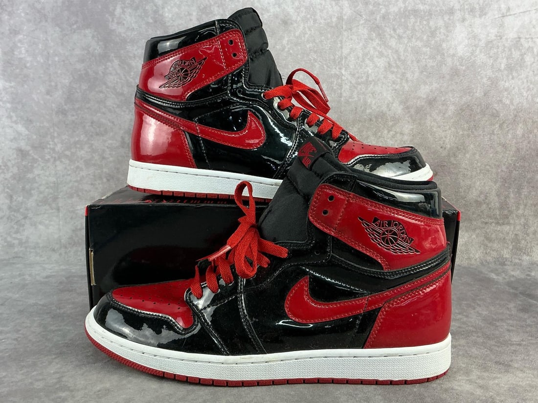 Air Jordan 1 Retro: Men's 2021 Nike Air Jordan 1 Retro High OG Patent Bred with black and red colorway. In good used condition and has lower of original box. US size 11.