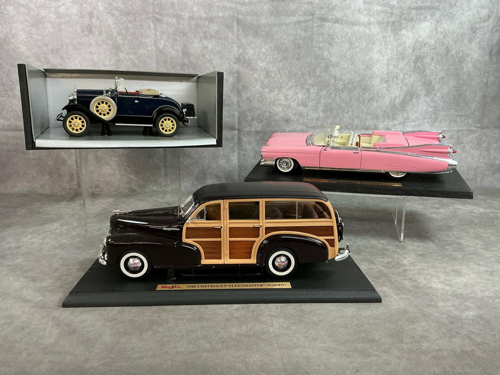Diecast Collectors Model Cars: Three antique classic collectible car replicas. 1959 Maisto Special Edition Cadillac Eldorado Biarritz 1:18 scale. 1948 Maisto Special Edition Chevrolet Fleetmaster Woody 1:18 scale. 1931 Motor City C