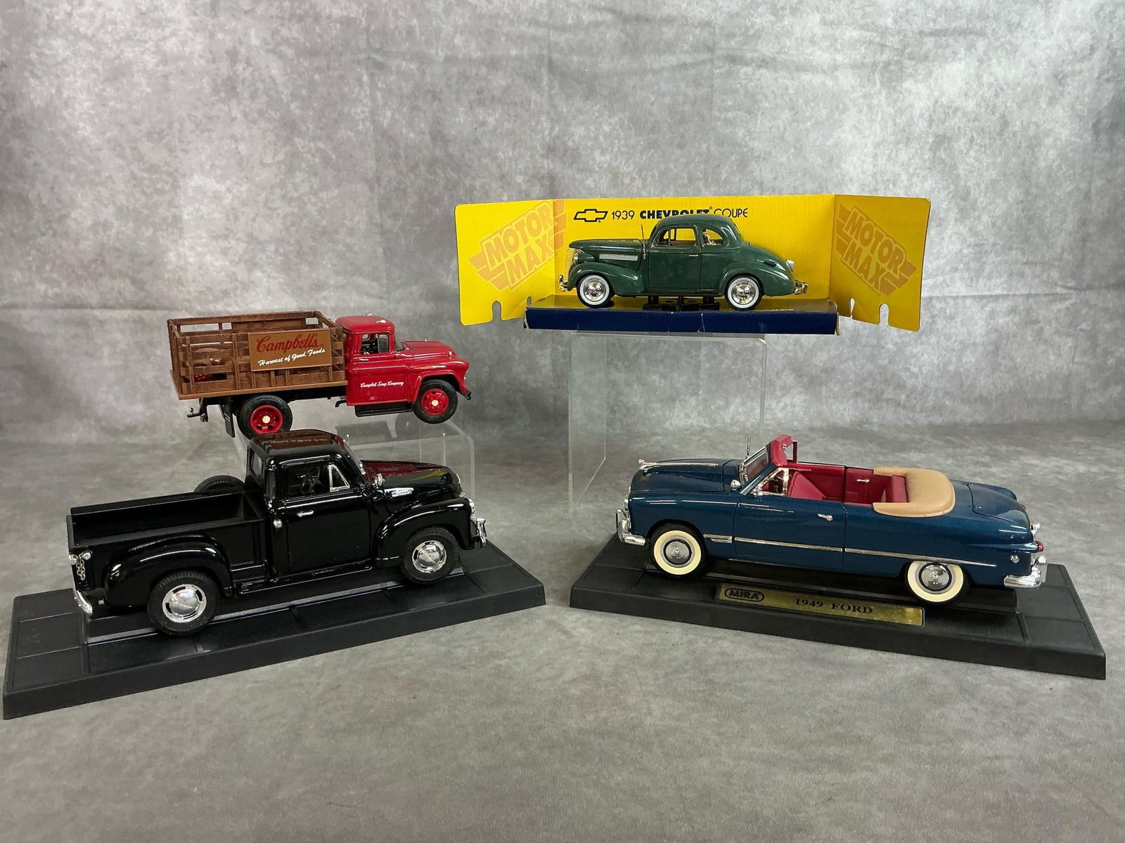 Diecast Collectors Model Cars: Four antique collector car replicas. 1939 Motor Max Chevrolet Coupe 1:24 scale. 1957 ERTL Campbells Soup Chevrolet Stake Truck. 1953 Mira Golden Line Collection Chevrolet Pickup truck 1:18 scale. 1949
