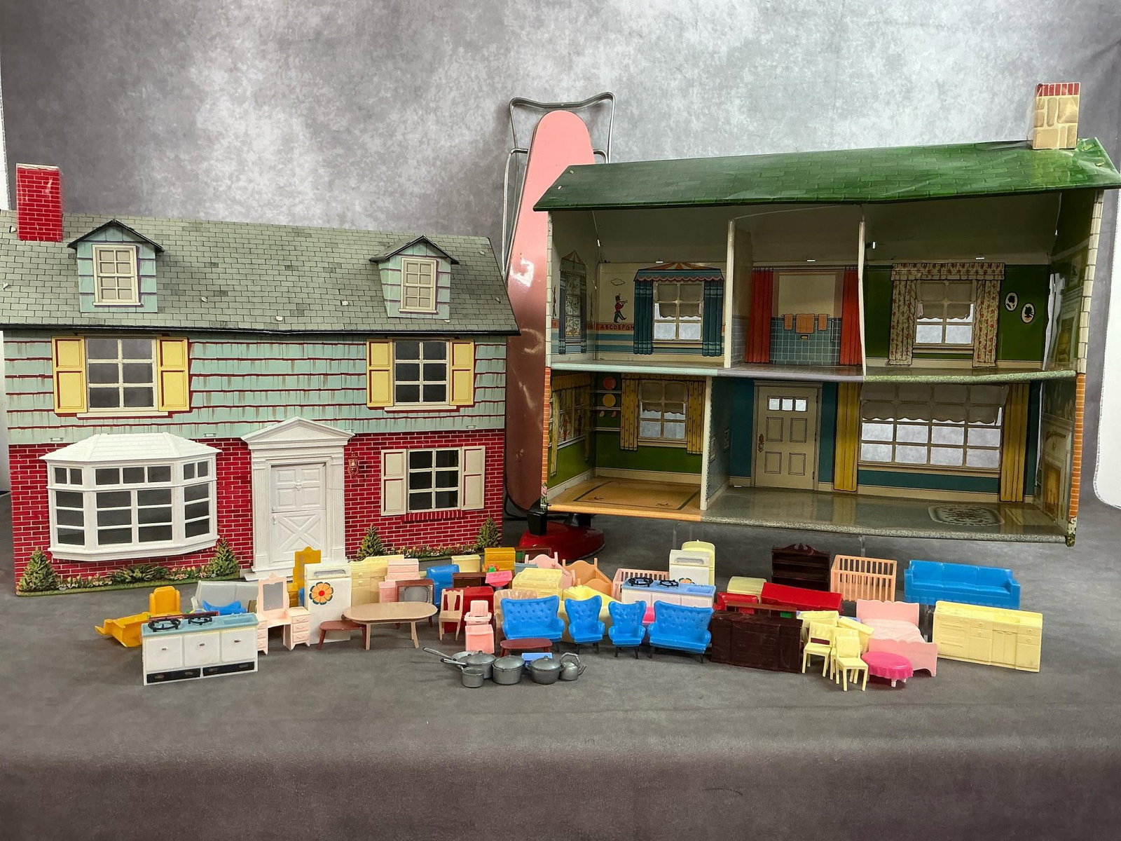 Toy Dollhouse's & Ironing Board: 1950's - 1960's Marx Tin Litho two story dollhouse with accessories. Wolverine folding metal ironing board and iron. Ironing board frame is bent. Dollhouses have normal wear for age and several access