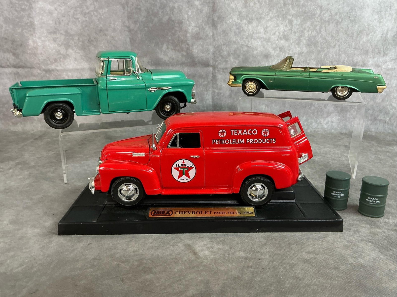 Collectors Model Cars Lot: Three antique classic car replicas. 1950 Mira Chevrolet Panel Truck with Texaco Petroleum Logo. 1961 Chrysler Imperial convertible. 1955 ERTL Chevrolet 3100 Stepside Pickup truck 1:18 scale. All in go