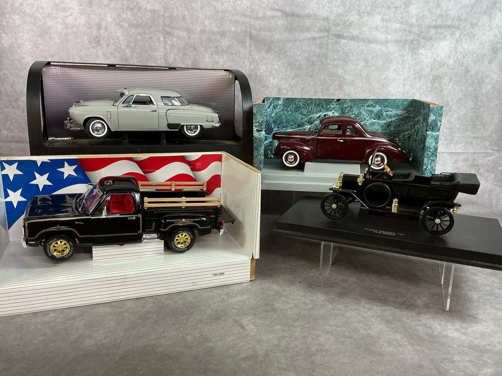 Collectible Vintage Cars: Four late 1900's model cars. Includes '51 Studebaker, Model T black Sedan, '78 Dodge Warlock, and '40 Ford Deluxe Coupe. Cars in good condition, boxes are worn and yellowed. Average box measures 14