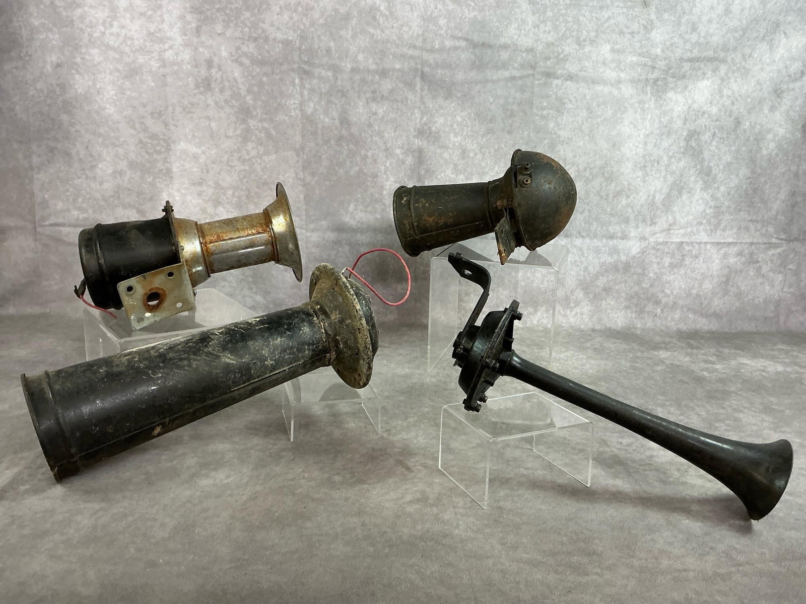 Collection Of Antique Car Horns: Four vintage original car/truck horns. The Electric Auto-Lite Co. 6 volt car horn with multi bolt mounting. Unmarked trumpet shaped horn with mounting bracket. Unmarked car horn with bracket. "Ahooga"