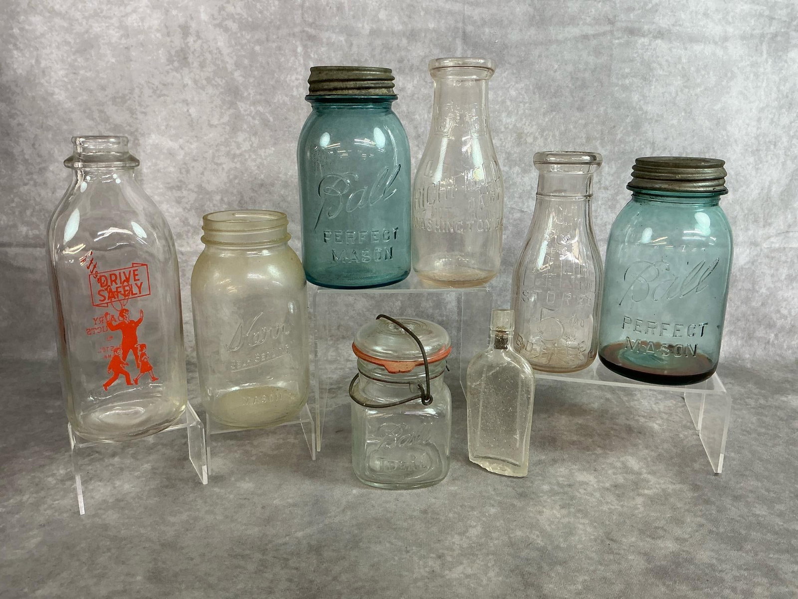 Mason Jars & Milk Bottles: Vintage blue and clear mason jars, milk jugs and a medicine bottle. Medicine bottle is chipped on bottom. Otherwise all in good condition. Blue mason jar measures 3.5 inches wide x 7 inches tall.
