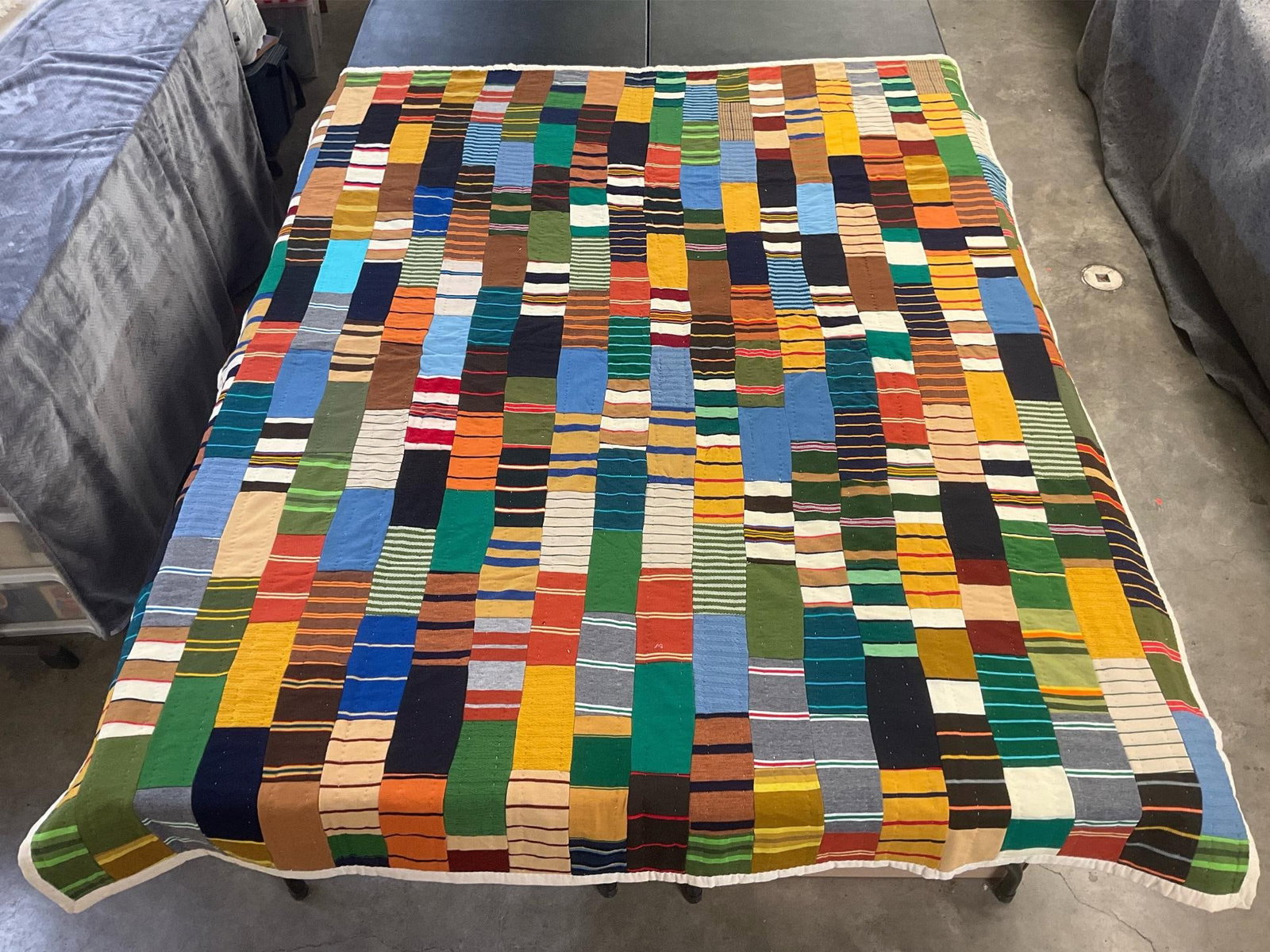 Military Ribbon Quilt: Vintage homemade quilt, some patches are of military service ribbons. Machine stitched, hand quilted. Good condition. Measures 66 inches wide x 81 inches long.