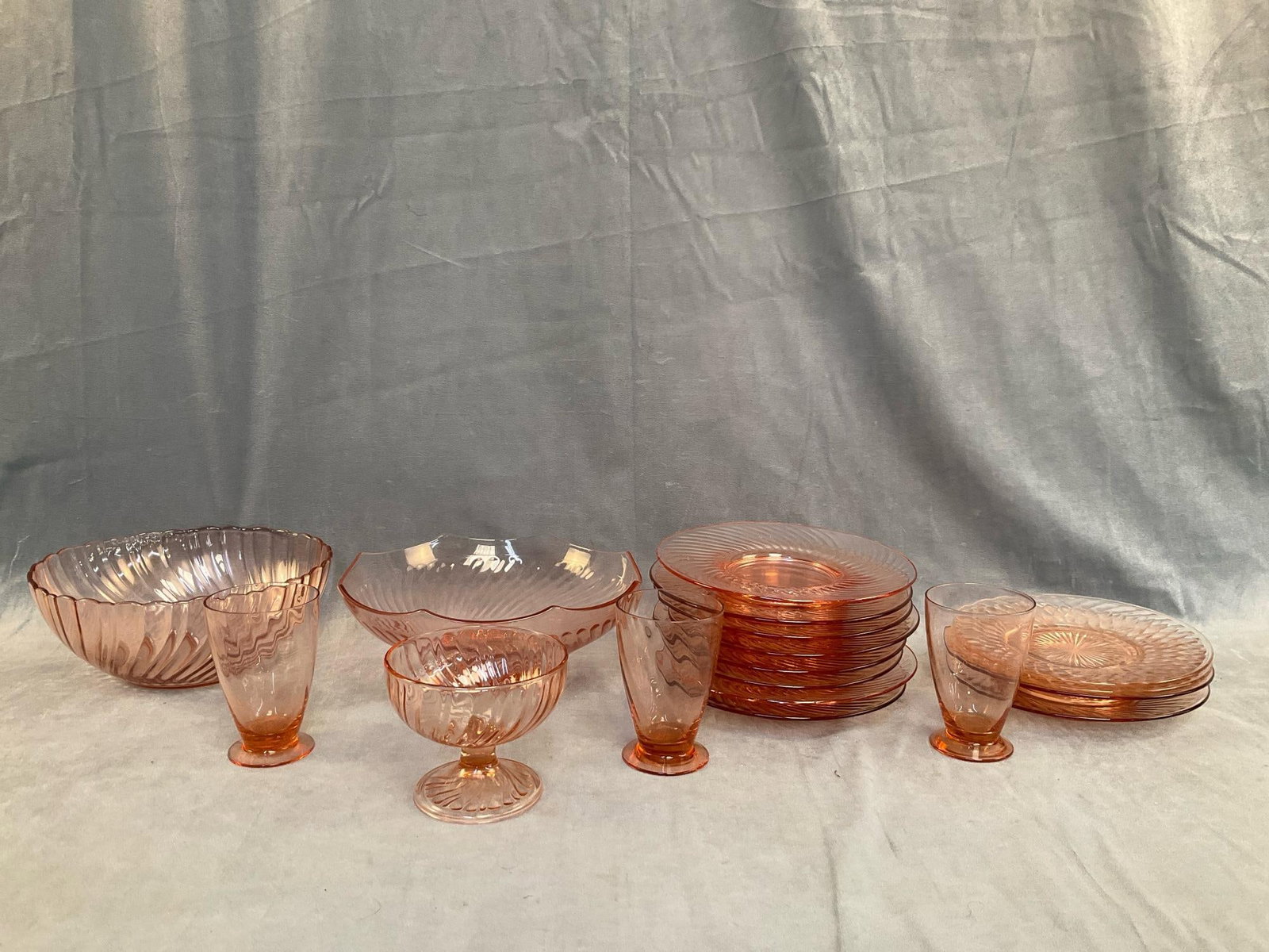 Depression Style Glassware: Mid-20th century Depression Style pink swirl eighteen piece glassware. Consists of; twelve plates, three glasses, one small bowl and two large serving bowls. One bowl marked "Arcoroc / FRANCE". One