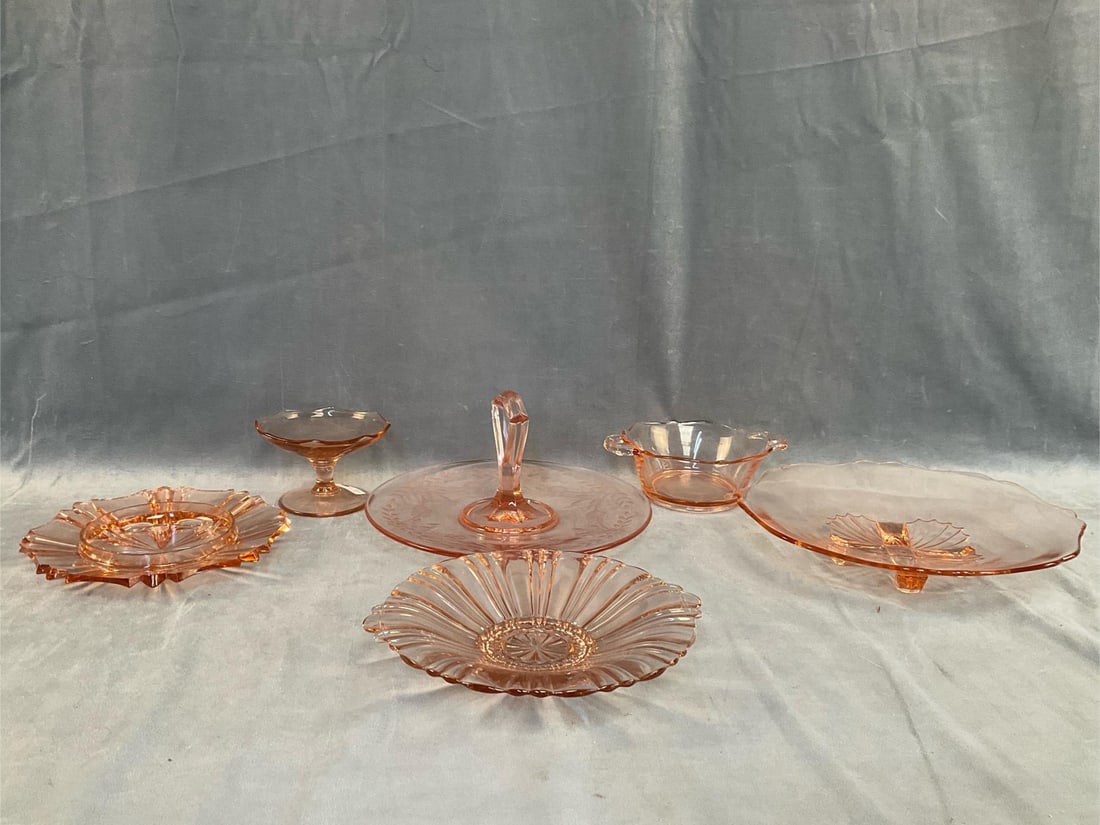 Depression Style Glass: Six pieces of mid-20th century pink depression style glass. Two candy dishes, one relish tray, two serving plates and one center handled server. Good condition. Server measures 10 inches in diameter