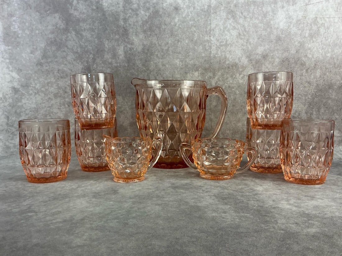 Pink Depression Glass: 1930s to 1940s Jeannette "Windsor" pink depression glass featuring a diamond pattern. Set for six, in good condition. Pitcher measures 3.5 inches in diameter at base x 6.5 inches tall.