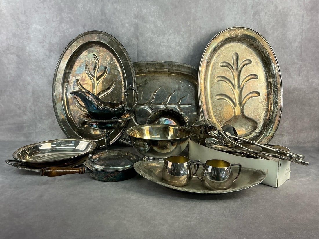 Silver Plated Serving Finds: Silver plated serving trays, utensils, bowls, and more. All in good condition with tarnish present throughout. Largest server measures 16 inches wide x 12 inches tall.