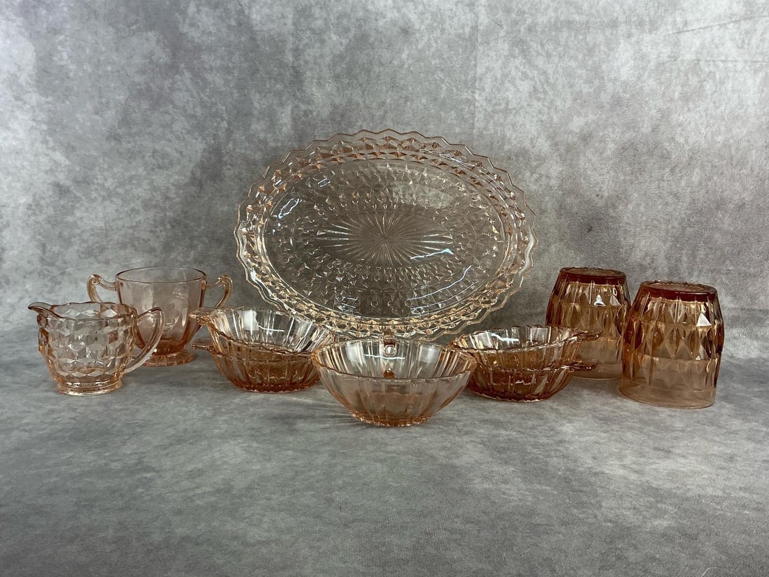 Pink Depression Glass: Ten pieces of pink depression glass including cups, creamer, sugarer, mini bowls, and more. All in good condition. Server measures 11.5 inches wide x 8.25 inches tall.