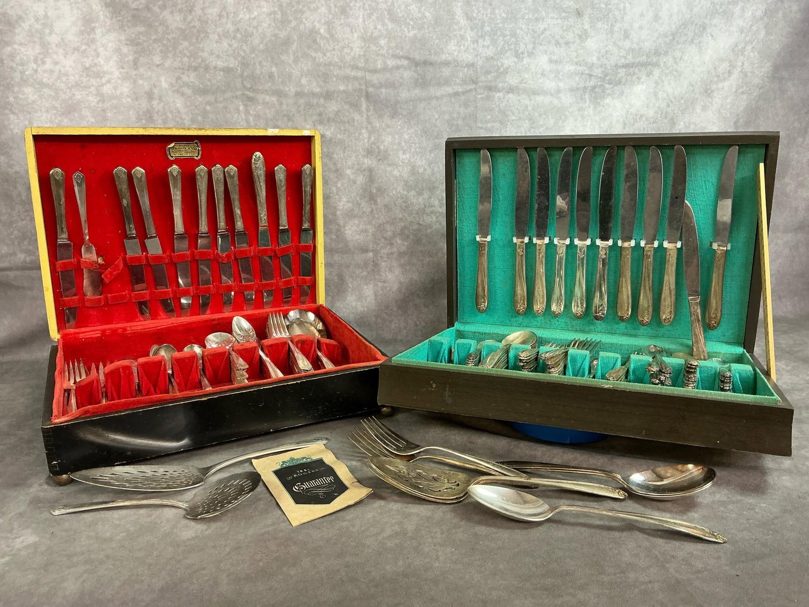 Rogers Flatware Sets: Two early to mid 1900's flatware sets in wooden boxes. Chevron pattern includes 63 pieces with extra servers. American Beauty Rose pattern (introduced in1909) includes 92 pieces with servers and