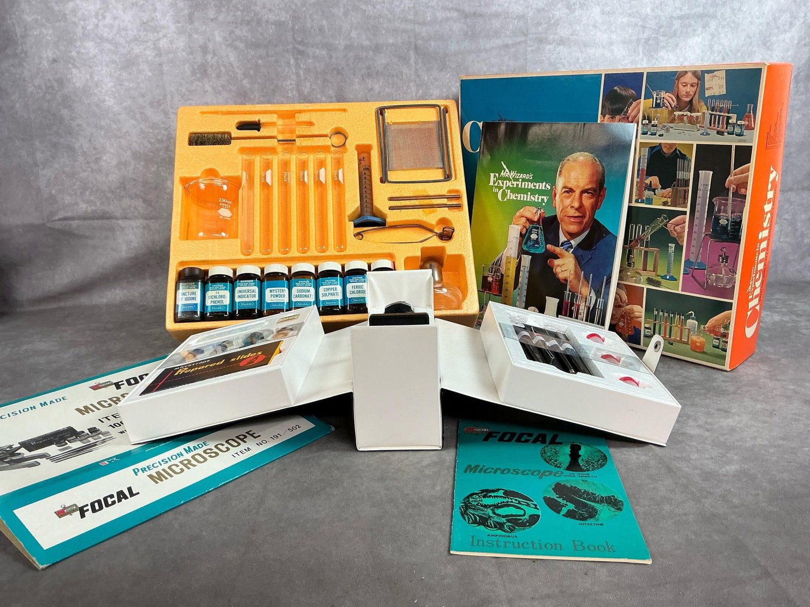 Microscope Set & Chemistry Set: Two 1970's Science sets. Mr Wizard Chemistry set complete in original box with book. Kmart Fical Microscope set in case with book, appears to be unused. Chemistry set measures 15.5 inches wide x 13 x