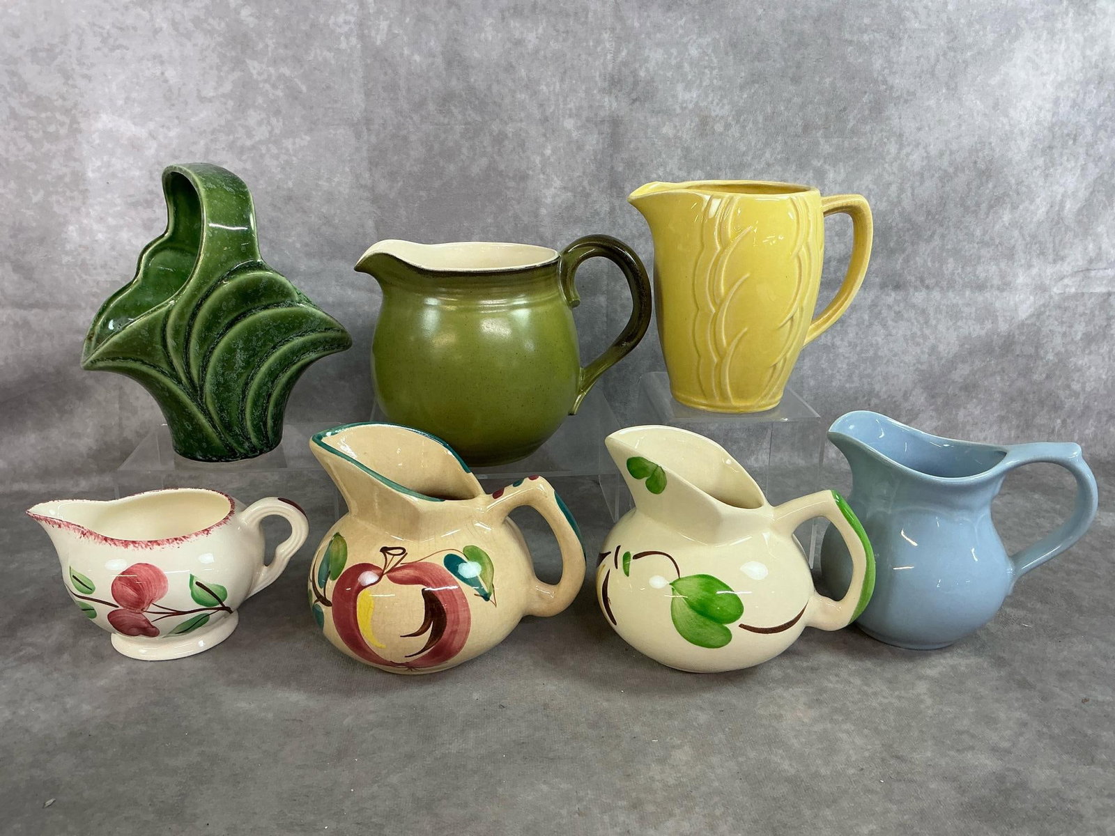 Creamers & Vase: Six vintage creamers and basket vase from mid to late 1900's. Includes Blue Pfaltzgraff creamer, yellow McCoy creamer, Purinton Pottery, Blue Ridge Pottery and more. Includes green basket vase by Impe