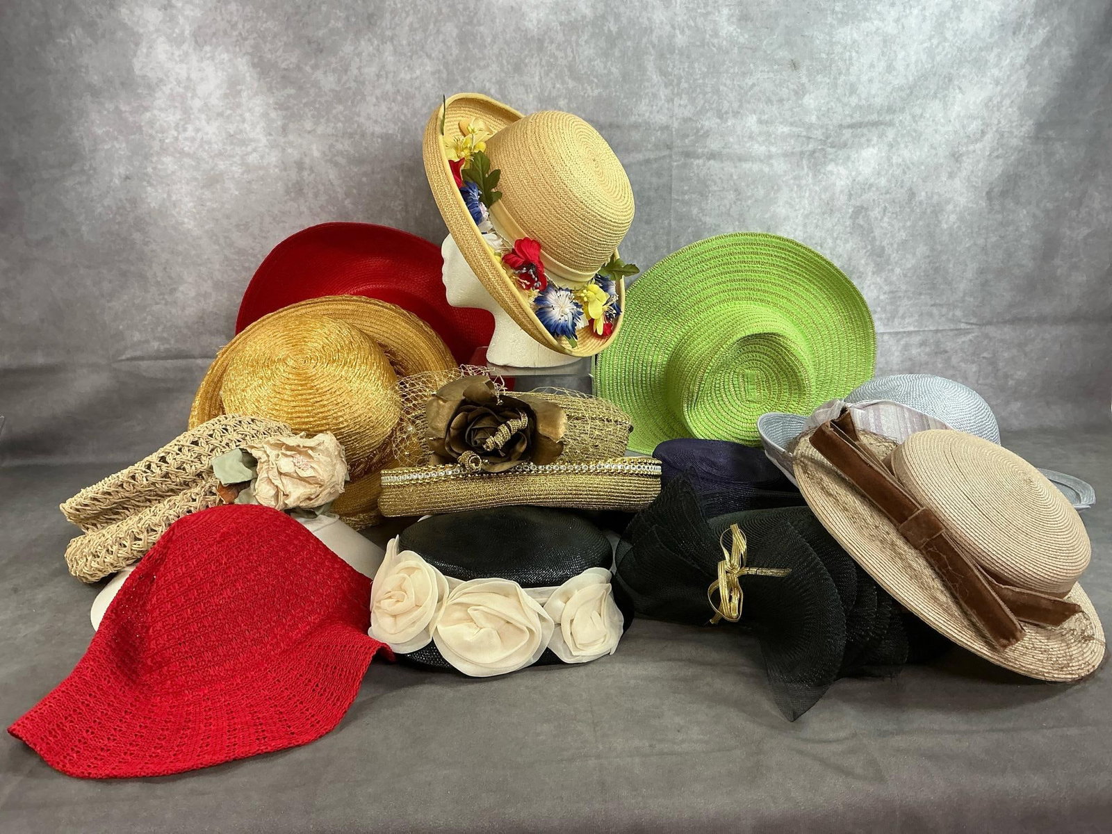 Sun Hats & Dress Hats: Thirteen modern style summer hats. Straw, mesh, cloth, crocheted, and more. Adorned with netting, ribbons, and flowers. Some wear but otherwise in good condition. Green floppy hat measures 15 inches