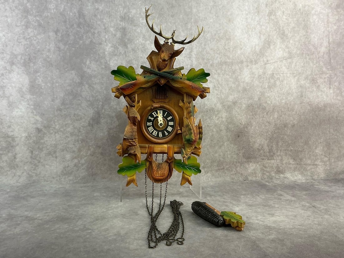 Cuckoo Clock: Black Forest hunting style mechanical cuckoo clock made of hand crafted wood. 1 weight is missing otherwise In good condition, although untested. Clock measures 6.75 inches wide x 14 inches tall.