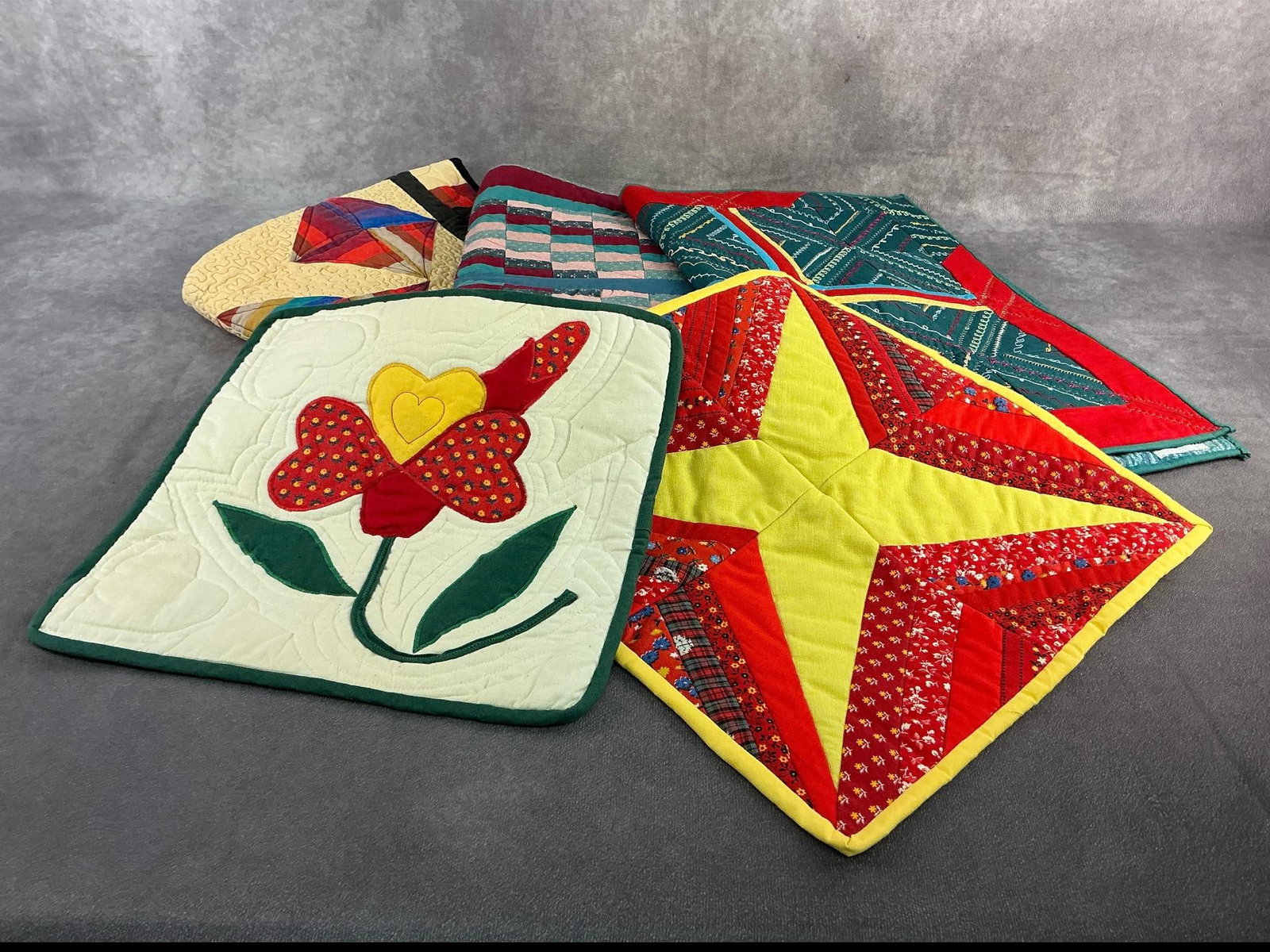 Quilted Tapestries: Five machine sewn quilted tapestries in a variety of sizes and styles. All tagged Nancy Moore originals and in good condition. Largest measures 29.5 inches wide x 27.5 inches tall.