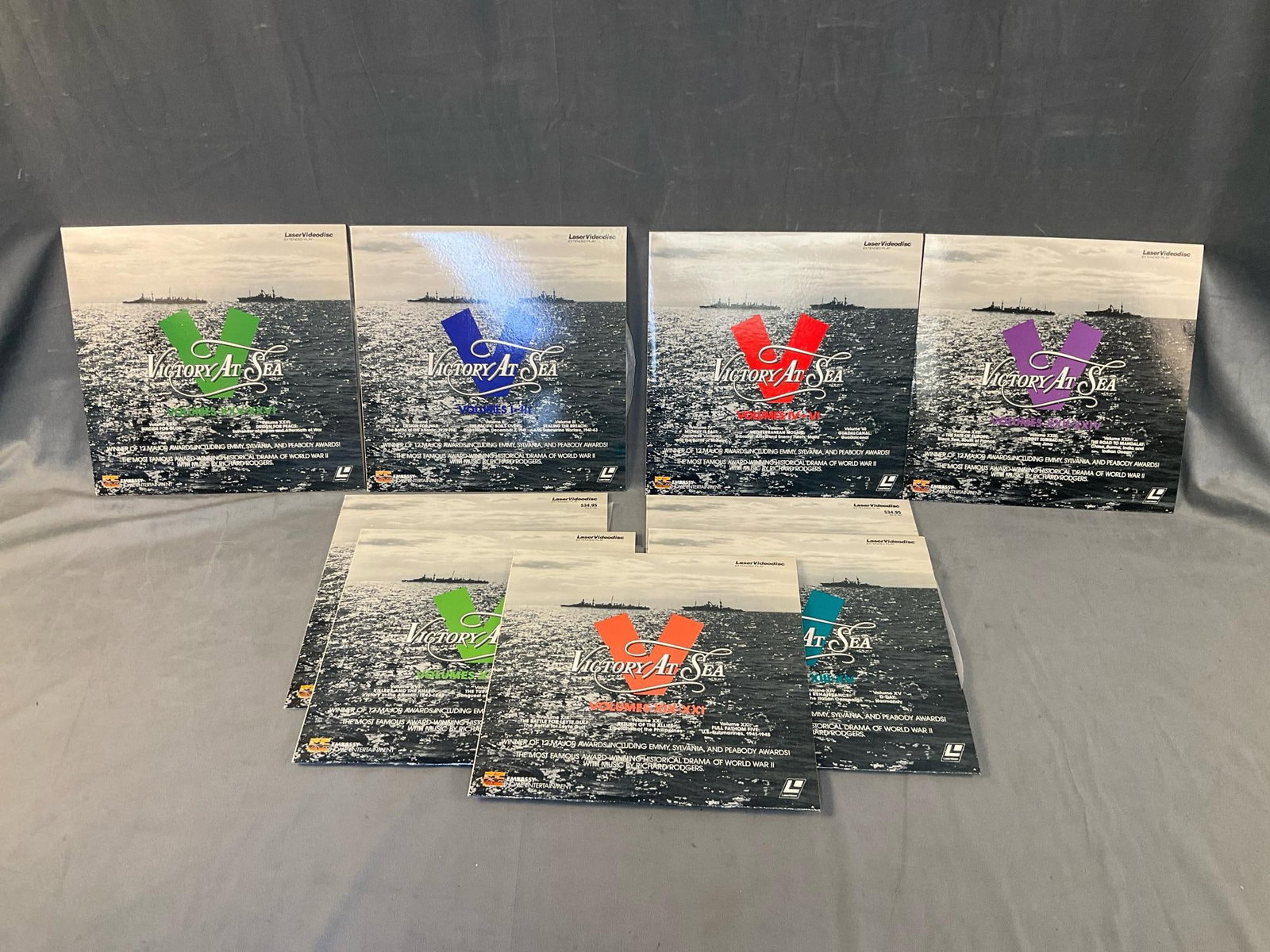 Laser Discs: Complete set of nine laser discs volumes 1-26 World War II documentaries titled "Victory at Sea". Not tested. Hand written notation accompanying set states side one of one not specified disc is