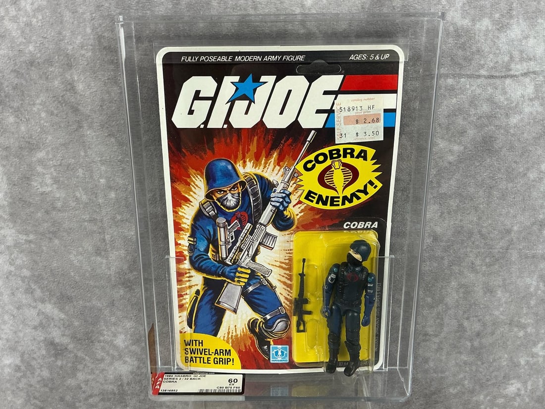 Cobra GI Joe 60 EX: 1984 series two 32 back G.I. Joe Cobra made by Hasbro made in Hong Kong. AFA graded 60 EX C80 B75 F60. Case measures 7.25 inches x 1.5 x 9.75 inches tall.