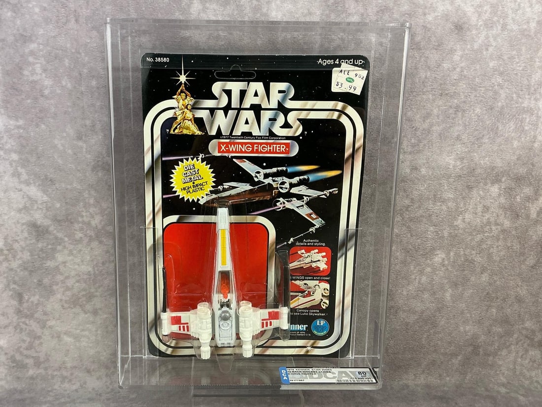 X-Wing Fighter 80 NM: 1978, 12 Back Star Wars diecast X-Wing Fighter made by Kenner in Hong Kong. DCA graded 80 NM with subgrades C75 B90 V85. Card is unpunched. Case measures 8.25 inches wide x 2 x 10.75 inches tall.