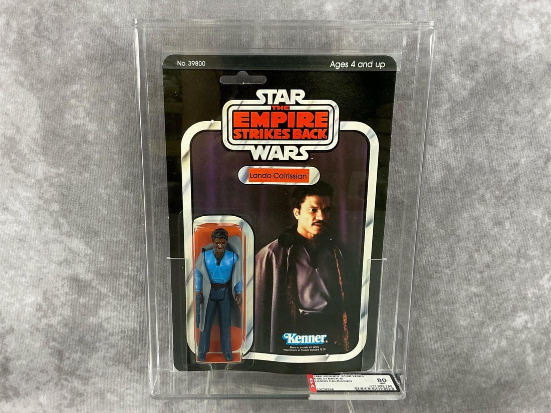 Lando Calrissian 80 NM: 1980, 31 Back-B Star Wars The Empire Strikes Back Lando Calrissian action figure made by Kenner in Hong Kong. AFA graded 80 NM with subgrades C75 B85 F80. Case measures 7.25 inches wide x 1.5 x 9.75