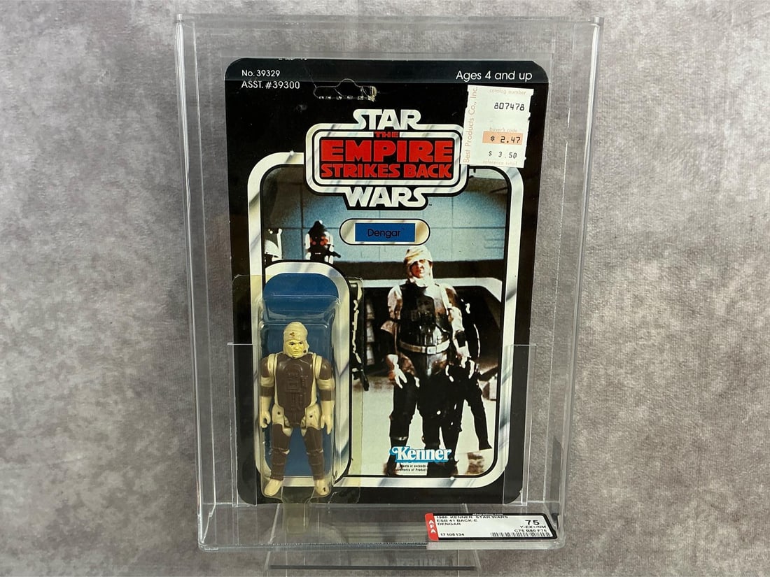 Dengar ESB 75 Y-EX+/NM: 1980, 41 Back-E Star Wars The Empire Strikes Back Dengar action figure made by Kenner in Hong Kong. AFA graded 75 Y-EX+/NM with subgrades C75 B80 F75. Card is unpunched. Case measures 7.25 inches wide