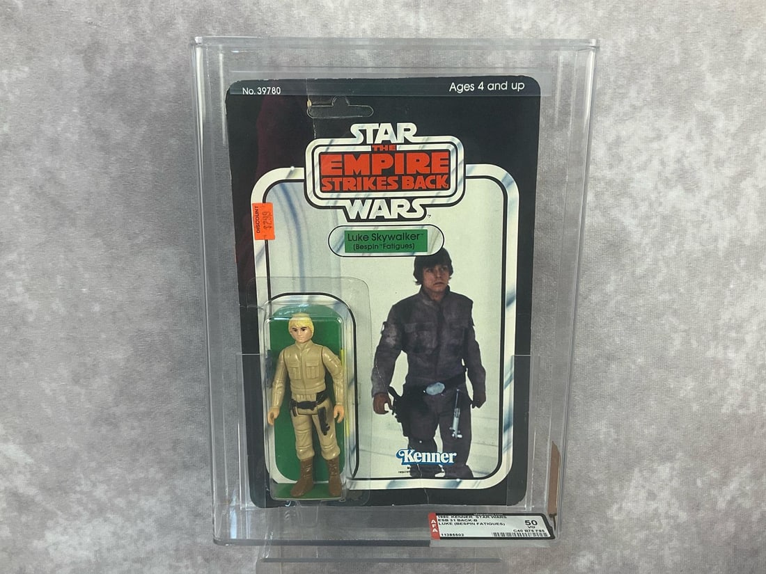 Luke Skywalker (Bespin Fatigues) ESB 50 VG: 1980, 31 Back-B Star Wars The Empire Strikes Back Luke Skywalker (Bespin Fatigues) action figure made by Kenner in Hong Kong. AFA graded 50 VG with subgrades C40 B75 F85. Card is unpunched. Case