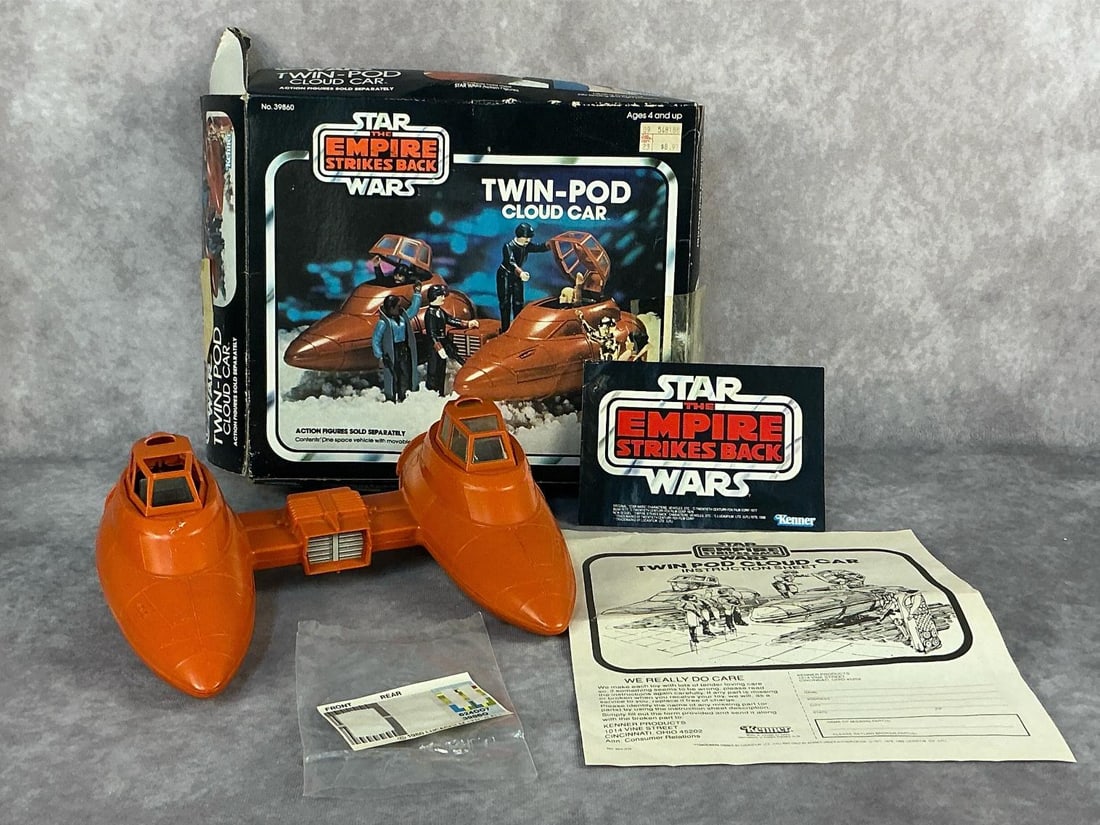 Twin-Pod Cloud Car: 1980 Star Wars The Empire Strikes Back Twin-Pod Cloud Car made by Kenner. In original box with paperwork. Car is missing windows on one side and has scuffs, box is damaged. Box measures 11.25 inches