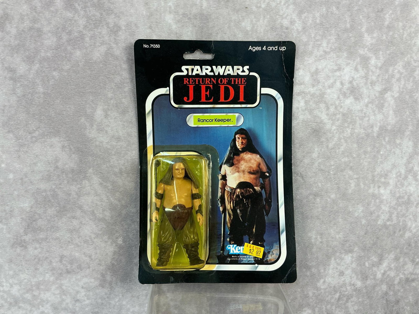 Rancor Keeper ROTJ: 1983, 77 Back-A, Star Wars Return of the Jedi Rancor Keeper Figure made by Kenner in Taiwan. Yellowing to blister and some dents, card back is bowed with creased corners. Measures 6 inches wide x 9 in