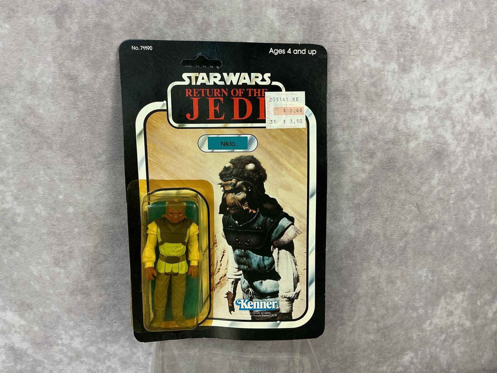 Nikto ROTJ: 1983, 77 Back-A, Star Wars Return of the Jedi Nikto figure made by Kenner in Hong Kong. Card is unpunched, yellowing to blister but in good condition, and bowing to card back. Measures 6 inches wide