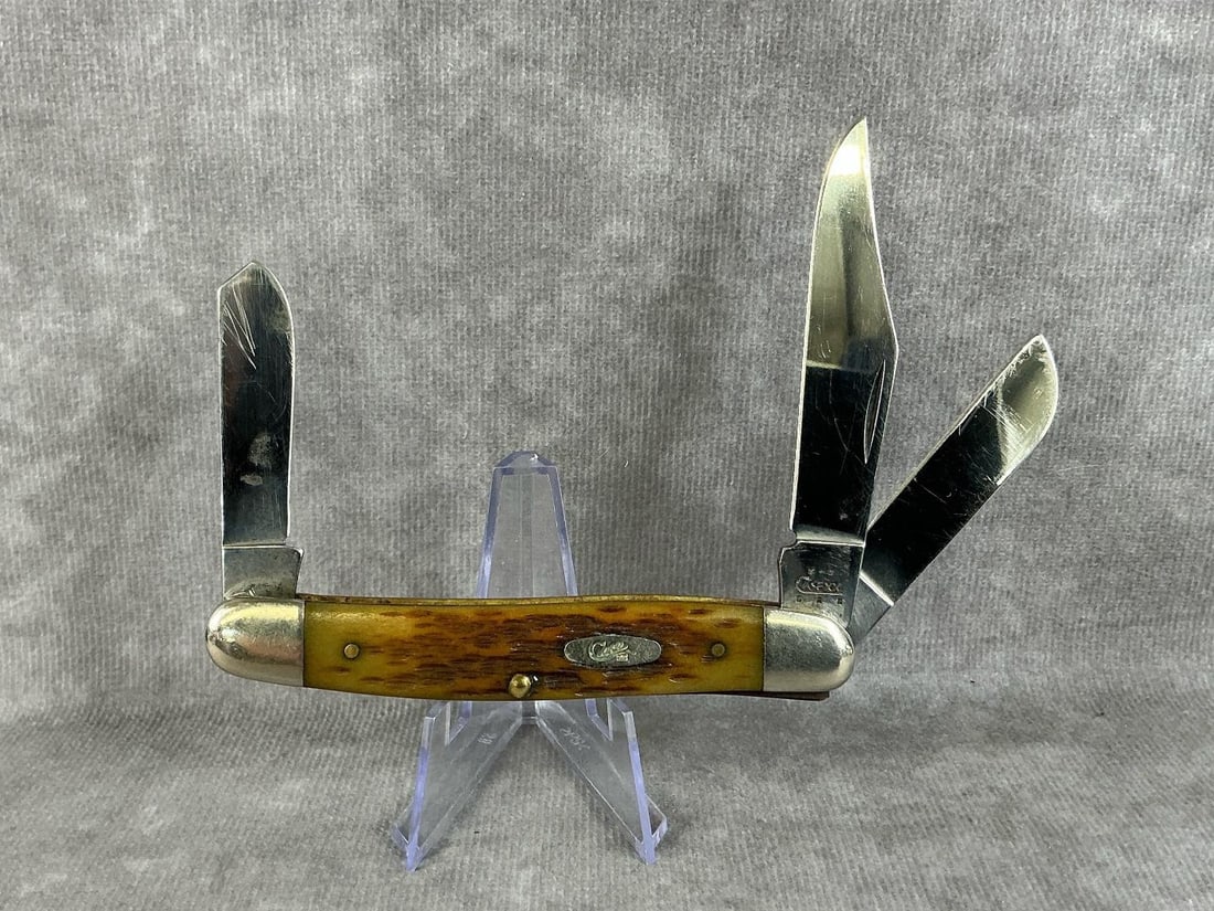 Stockman With Bone Handle: 2004 Case XX three blade stockman with jigged amber bone handles, 6347 SS. Tight snap, oxidation on blades, scratches to blades. Measures 4 inches long closed.