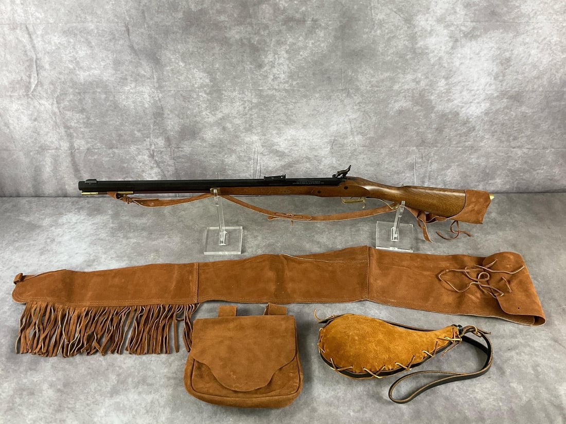 Traditions Hawken Woodsman .50 Caliber Rifle: Serial # 14-13-002520-96 Hawken Woodsman .50 caliber muzzleloader rifle and suede accessories by Traditions in brown wood and blued steel. In good condition. Clean bore never fired. Barrel length 25