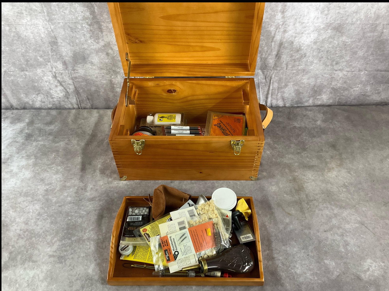 Mixed Brand Muzzleloading Accessories and Storage Cases: Muzzleloading range storage cases and .45 to .50 caliber shooting accessories by Remington, Thompson/Center, and mixed brands in assorted colors. In good condition. Including powder flask, cap tool,