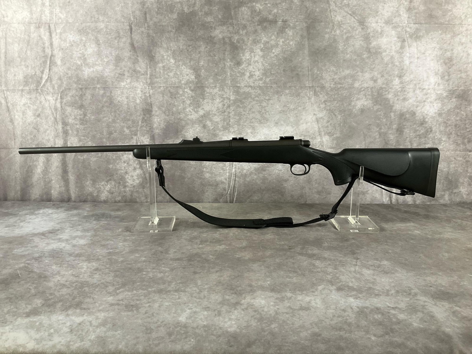 Remington Model 700 Bolt-Action Rifle: Serial # E6385775 Model 700 bolt-action rifle by Remington in matte black, synthetic stock. In good condition, with clean bore. Includes attached sling. Barrel length 23 inches, overall length 42 1/4