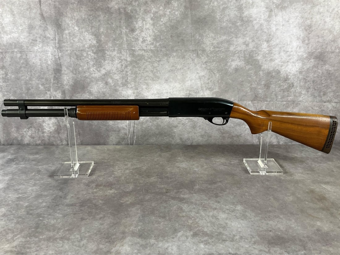 Remington Model 870 Wingmaster Pump-Action Shotgun: Serial # V184002v Model 870 Wingmaster 12-gauge pump-action shotgun by Remington in a blued metal and wood finish. In good condition with a clean bore. Surface scratches, scuffing and a gouge on the