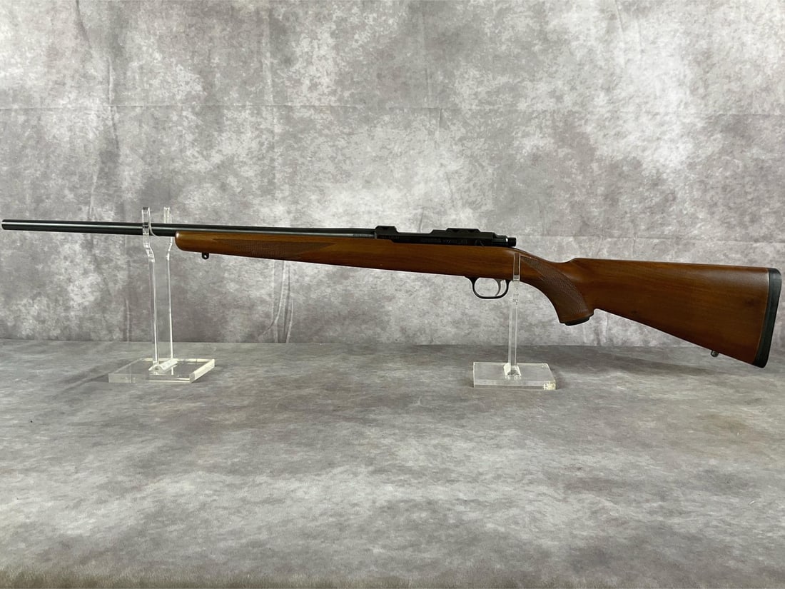 Ruger 77/22 Bolt-Action Rifle: Serial # 701-17586.22 WMR 77/22 Bolt-Action Rifle by Ruger in a wood and blued finish. In good condition. Clean bore. Barrel length 22 inches, overall length 39 1/4 inches.