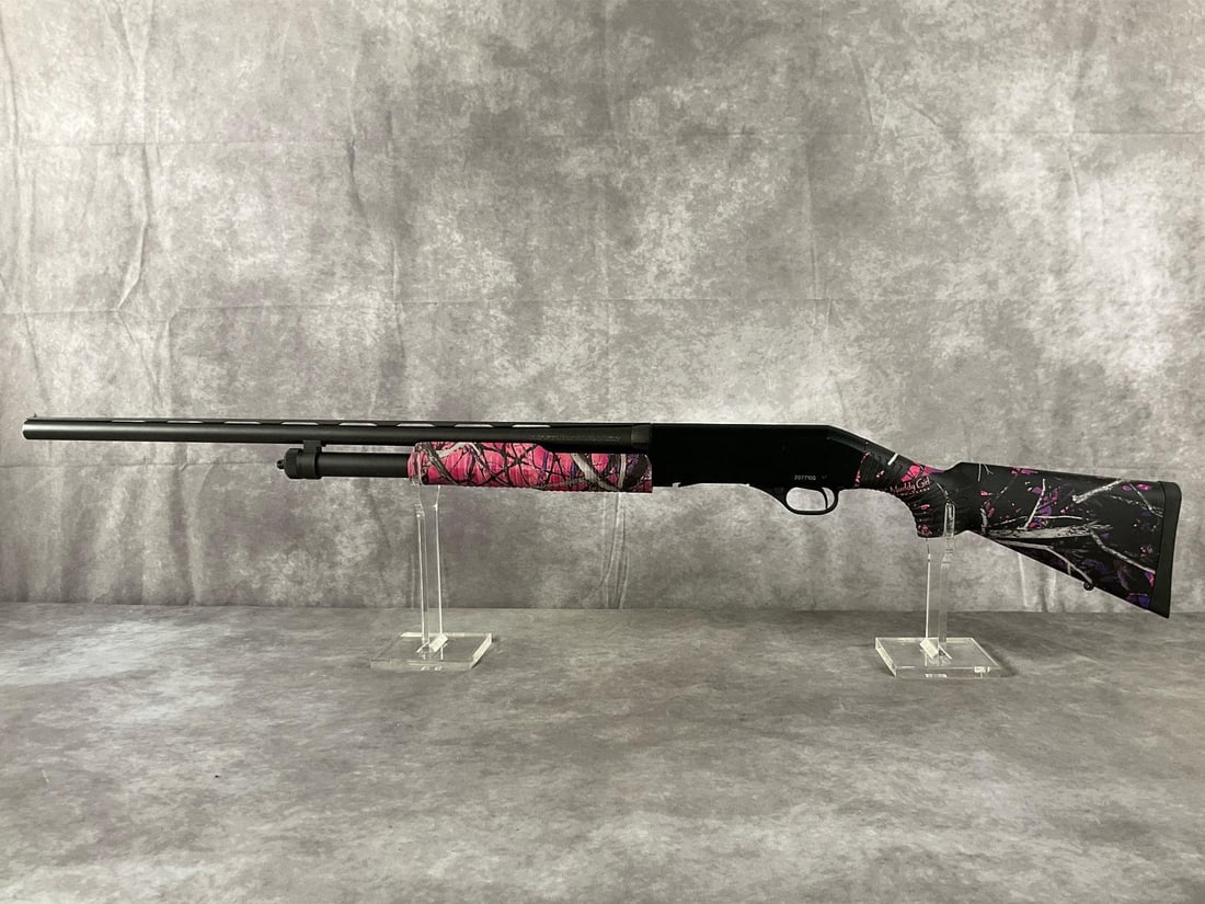 Stevens Model 320 Pump-Action Shotgun: Serial # 2077100 20-gauge Model 320 pump-action shotgun by Stevens in matte black and Muddy Girl pink camouflage. In good condition. Clean bore. Barrel length 26 1/2 inches, overall length 46 inches.