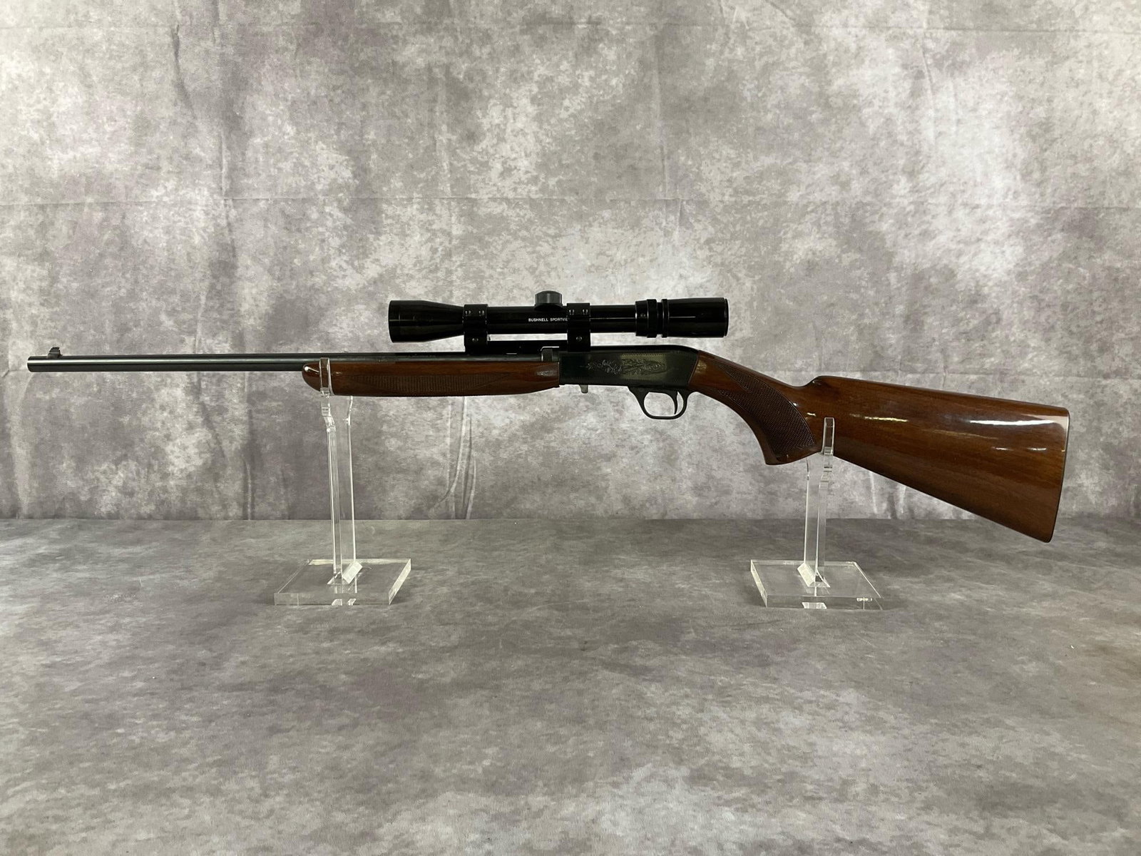 Browning SA-22 .22 Rifle With Scope: Serial # 04478PY146 Model SA-22 .22 LR semi-automatic rifle with Bushnell Sportview scope and denim case by Browning in blued metal and high-gloss wood finish. Clean bore and In good condition with
