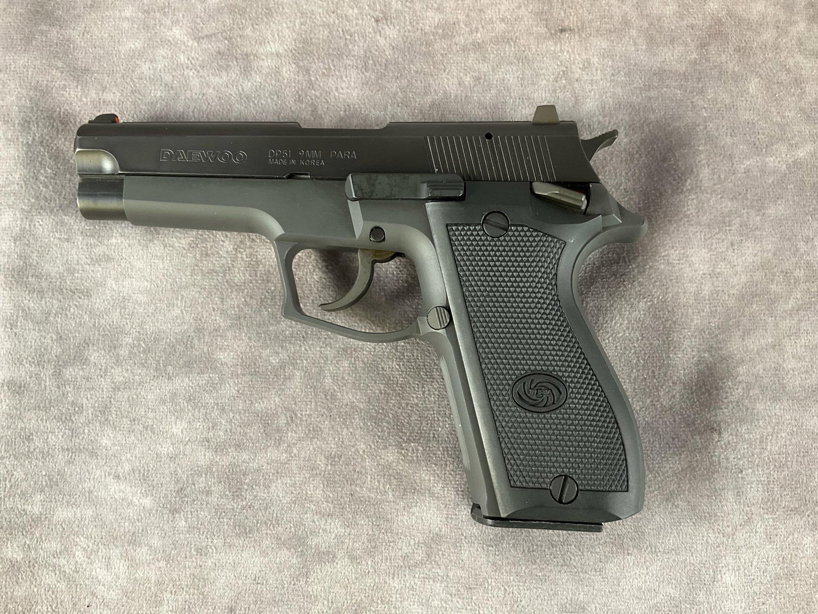 Daewoo DP51 9mm Semi-Automatic Pistol: Serial # BA900724 Model DP51 9mm semi-automatic pistol by Daewoo in color matte black. In good condition with slight finish wear. Includes box and three magazines. Barrel length 4 inches, overall