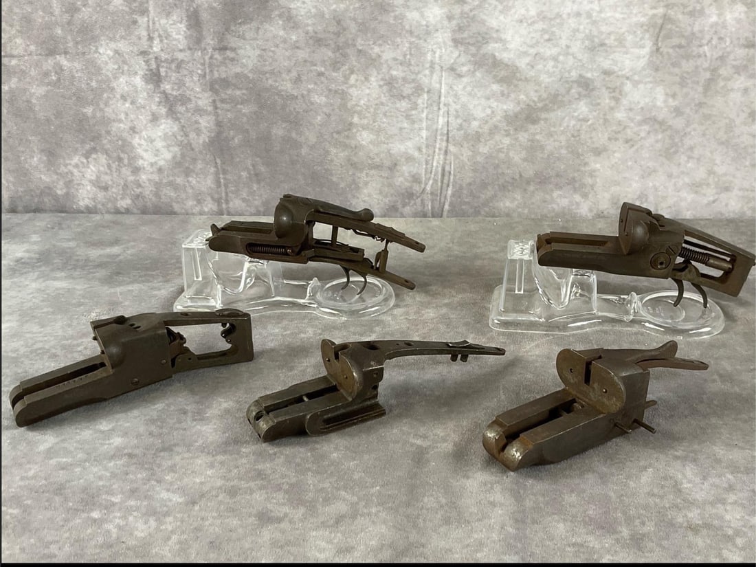 Ithaca, J. Stevens and others. Shotgun Receivers: Five total Antique firearm break-action receivers, parts, and tool components by Ithaca, J. Stevens, and others in dark bare metal. In poor condition with heavy surface rust, severe oxidation,