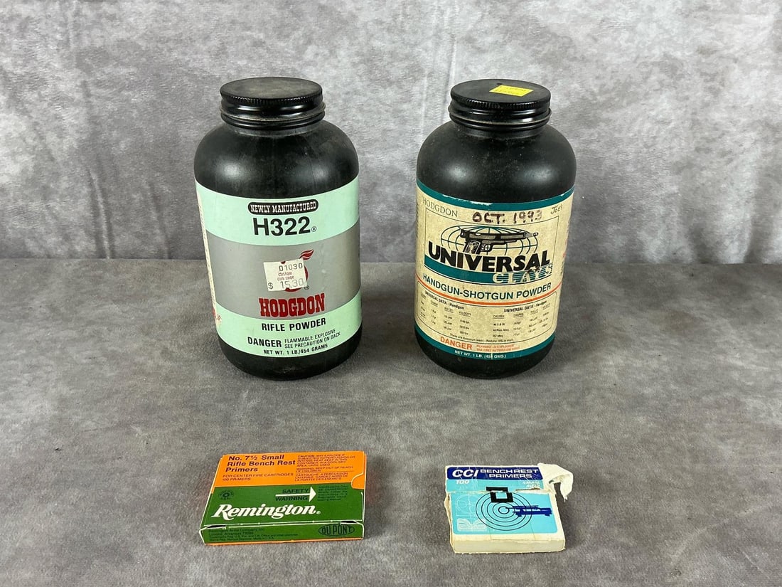 Hodgdon, Remington & CCI Reloading Supplies: H322 and Universal Clays and Hodgdon powder with benchrest primers by Remington, and CCI. In good condition with light surface dust and minor scuffing on the bottles. Bottle measures 6 1/2 inches