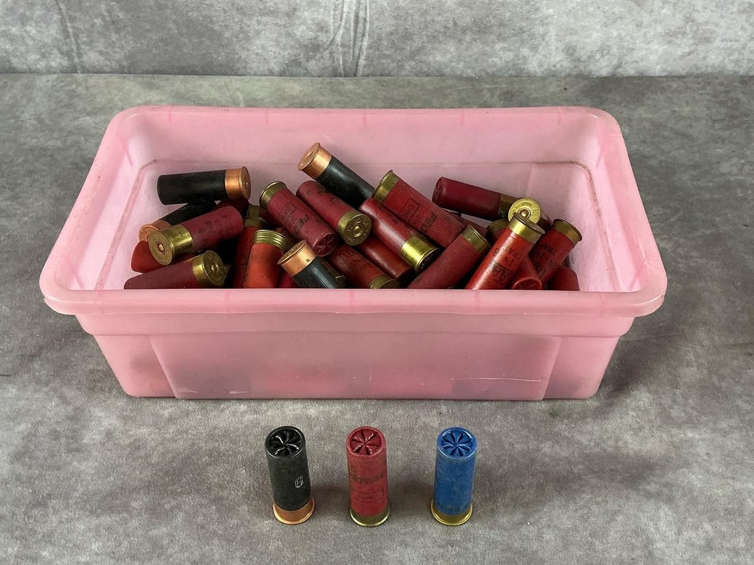 Winchester, Remington, Federal 12 Gauge Shells: 50 plus 12 Gauge shotgun shells by Winchester, Remington, Peters, and Federal in red, black, and blue. In fair condition with metal tarnish, minor oxidation. Container measures 12 3/4 inches long X 7