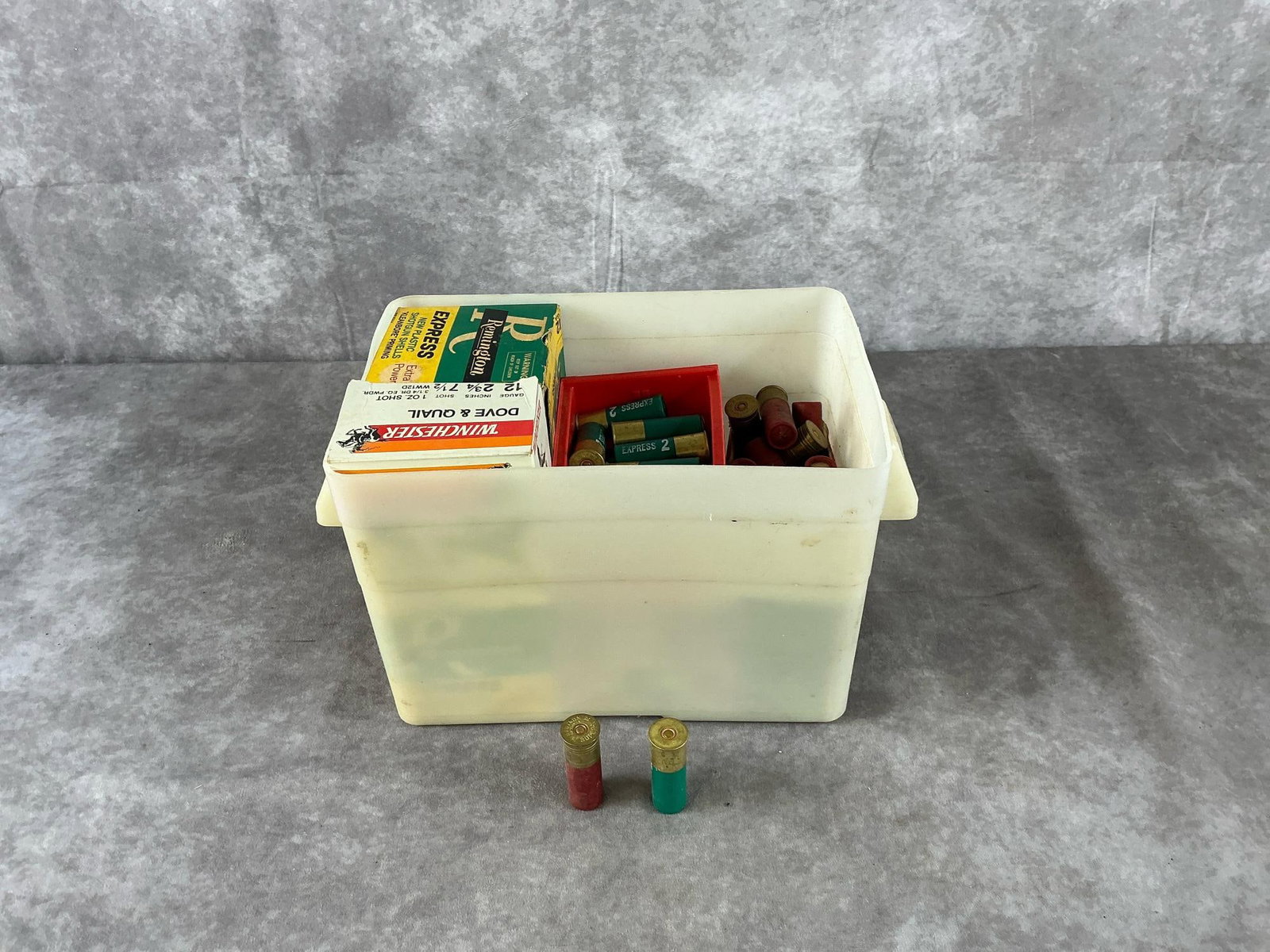 Federal Remington Winchester Mixed Shotgun Shells: 100 total 12 and 16 gauge shotgun shells with storage tubs by Federal, Remington, Winchester, and Fiocchi in mixed colors. All in good condition. Container measures 15 inches long X 7 1/2 inches wide