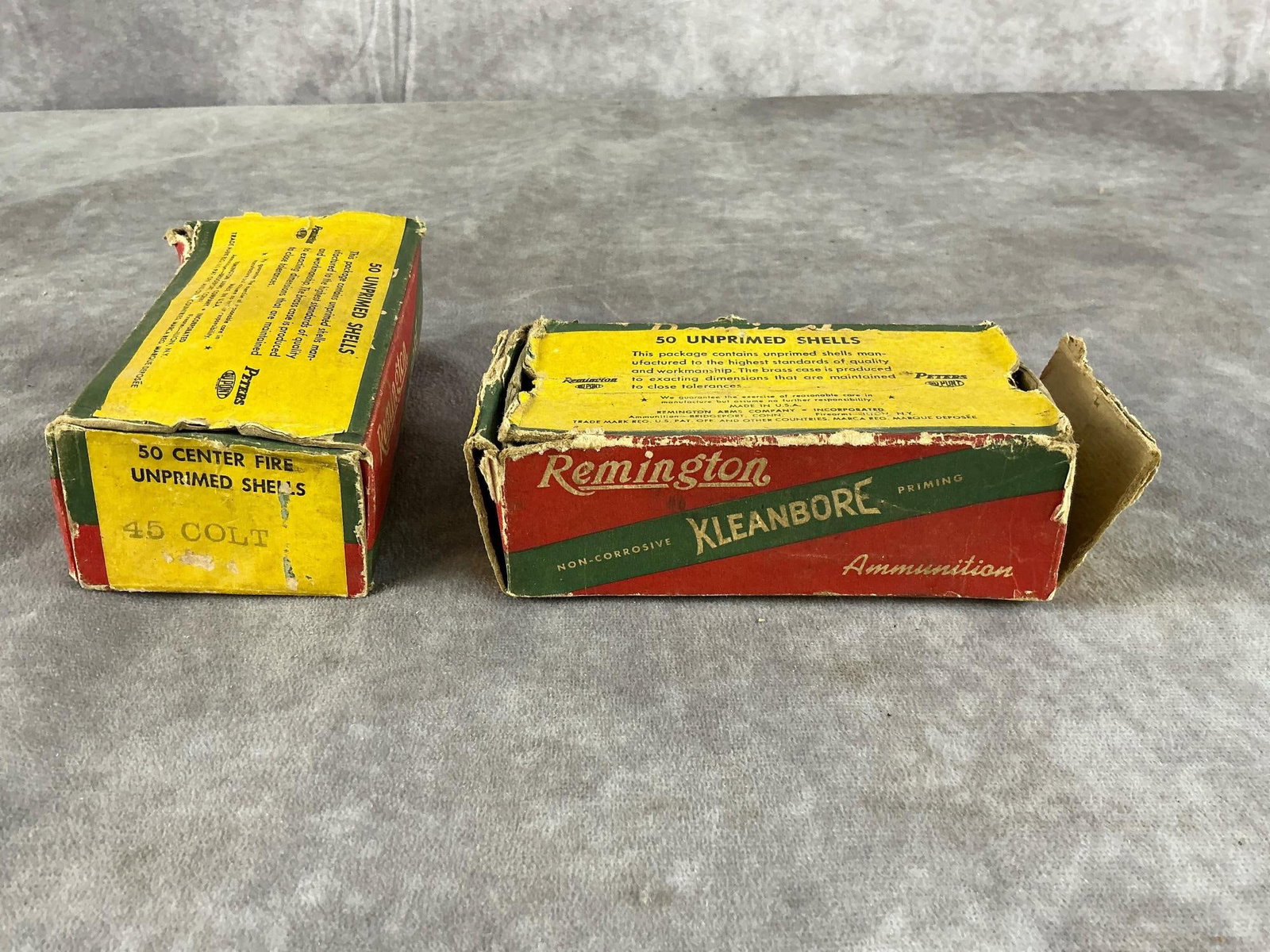 Remington .45 Colt Ammunition: 57 total vintage .45 Colt shells by Remington in brass. In fair condition. Box measures 5 inches long X 2 1/2 inches wide X 1 3/4 inches high.