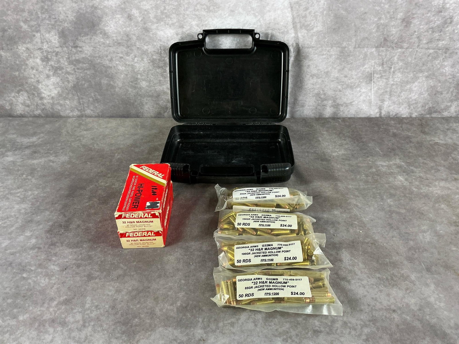 .32 H&R Federal and Georgia Arms Ammunition and Case: 293 total Federal and Georgia Arms .32 H&R Magnum Jacketed Hollow Point and Hi-Power ammunition included with a black hard plastic case. In good condition. Case measures 10 1/2 inches long X 8 1/2