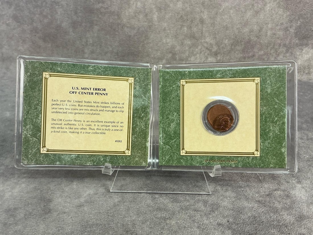 Misstruck Penny: US mint error, off center penny. In good condition and comes in commemorative mini binder. Binder measures 4.25 inches wide x 3.5 inches tall.