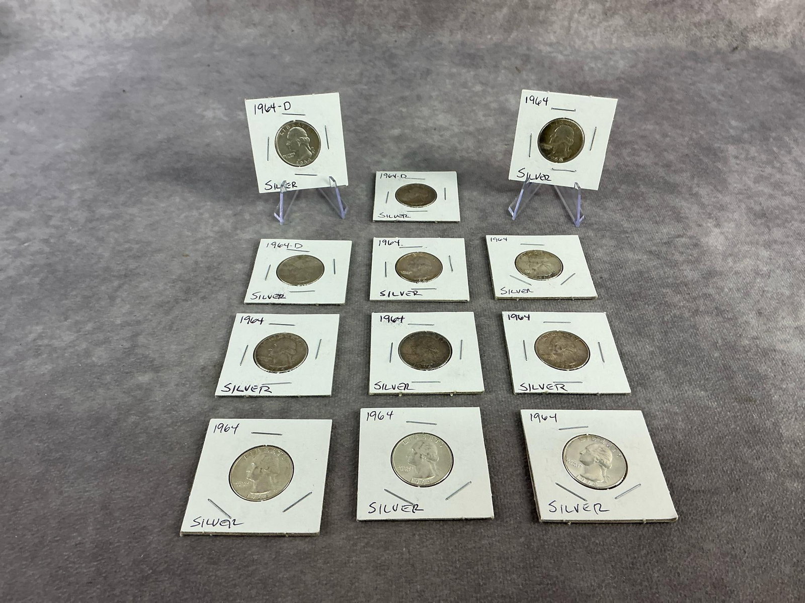 1964 Quarters: Twelve 1964 Washington head quarters. All in good circulated condition. Total weight 3.28 ozt.